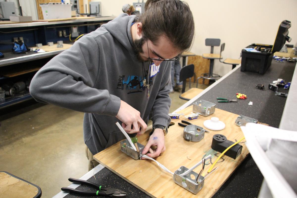 Student working on electrical circuit.