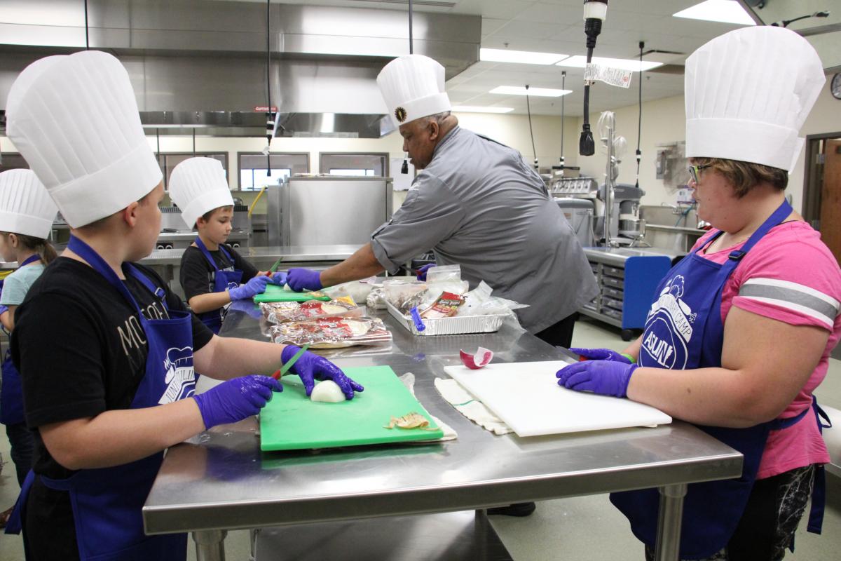Chef Kevin Gee working with students at this summer's Junior Culinary Camp