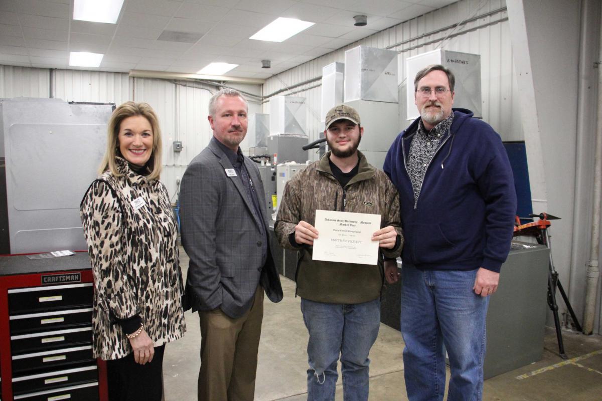 Pictured from left to right: Dr. Sandra Massey, Chancellor, Robert Burgess, Dean of Applied Science, Matthew Privett (Second Place), and Chad Stoddard, Marked Tree High School Instructor.